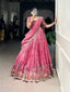 Model showcasing a premium candy pink silk Chaniya Choli featuring a traditional multi-color Pichwai style embroidery border with horses and trees, a heavily detailed matching blouse, and a draped dupatta inside a boutique showroom.