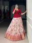 Woman showcasing a premium cream floral print Chaniya Choli with a thick gold zari border and a solid crimson red peplum long blouse inside a boutique store setup.