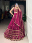 Model showcasing a premium wine deep magenta silk Chaniya Choli featuring heavy golden zari thread-work, architectural panel border embroidery, a matching sweetheart neck blouse, and a rich scalloped dupatta inside a boutique.