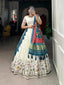Model showcasing a premium off-white silk Chaniya Choli featuring a traditional multi-color Kalamkari peacock print border and a heavy teal Patola print dupatta with gold zari work inside a boutique.