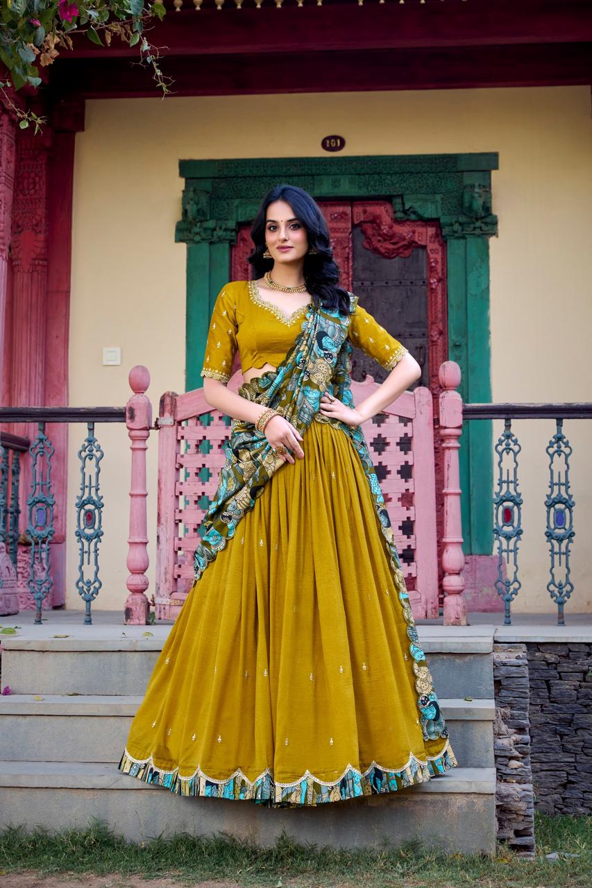 Model showcasing a premium mustard yellow georgette Chaniya Choli featuring an intricate multi-color Patola print scalloped border, a matching silver zari embroidered blouse, and a draped Patola dupatta inside an outdoor heritage courtyard. Main image