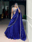 Model showcasing a premium royal blue georgette Chaniya Choli in a saree-drape style, featuring a heavily embroidered silver zardosi sleeveless blouse and a scalloped border dupatta inside a boutique showroom.
