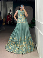 Model showcasing a premium sage green woven silk Chaniya Choli with fine gold zari floral bouquets and a matching sleeveless long tunic choli blouse inside a boutique store setup.